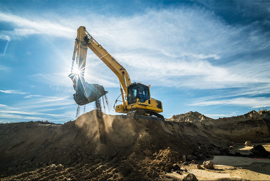 Construction - digger working on site on sunny day