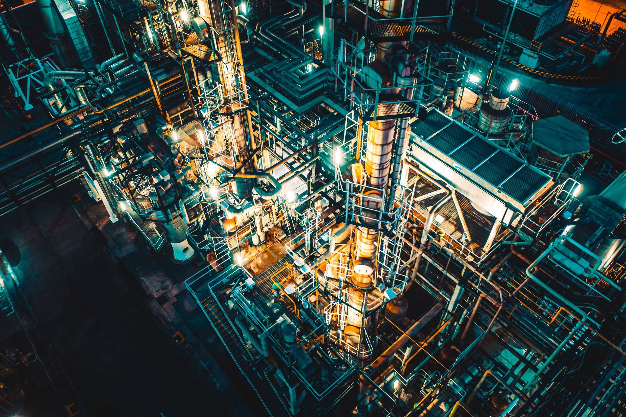 Drone view of Petro chemical oil processing refinery plant by night